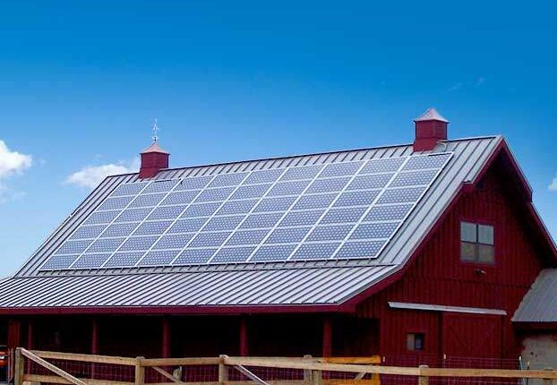 solar panels on red barn rooftop